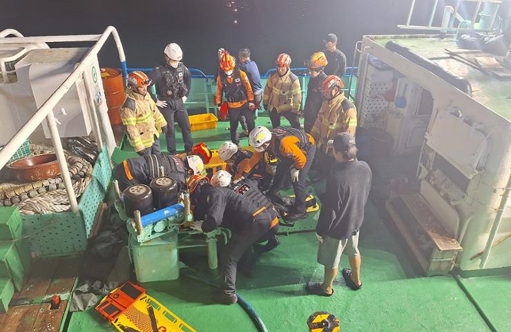 Rescued crew members are taken to a nearby port after their fishing boat sank off the coast of Jeju Island, Friday, in this photo provided by the Jeju firefighting and safety headquarters. Yonhap 