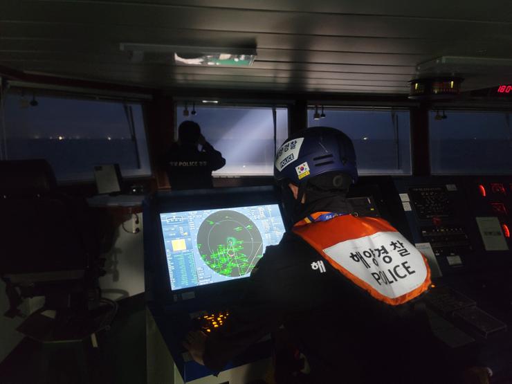 Coast Guard officers search for missing crew members aboard the 129-ton Geumseong that sank off Jeju Island the previous day, in this photo provided by the Jeju Coast Guard, Nov. 9. Yonhap